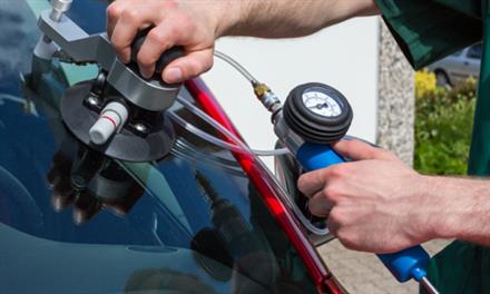 person repairing a windshield